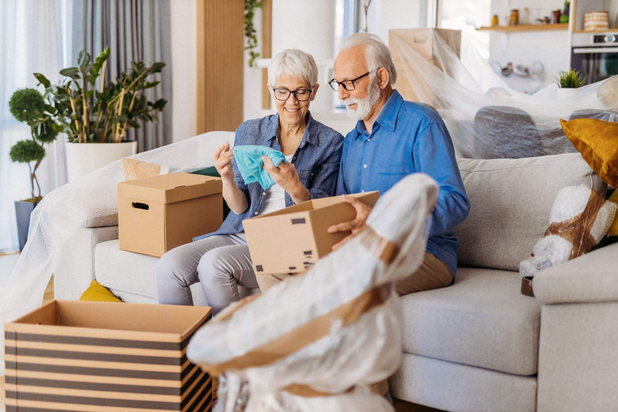 Senior couple unpacking and looking through their items together.