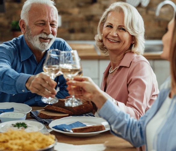 Friends cheer over dinner at a table