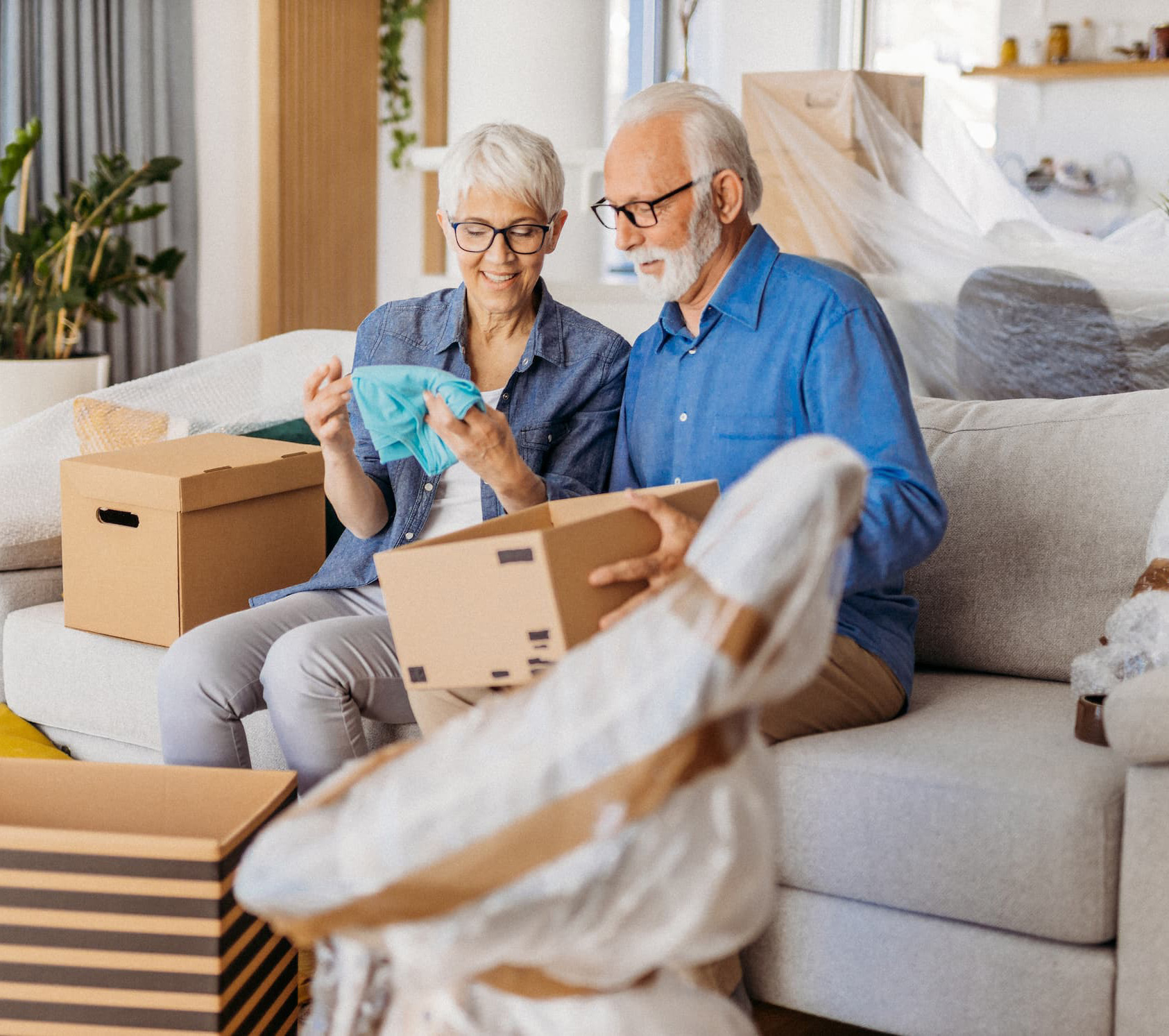 Retired couple unpack memories from boxes