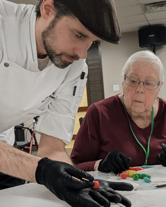 Senior woman watches chef during lesson