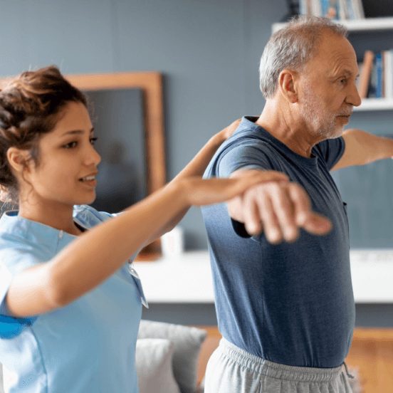 Senior man extends arms while nurse supports