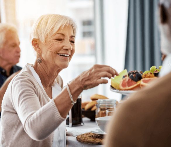 Woman takes fruit off of tray